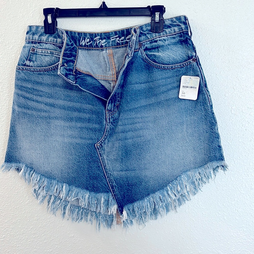 NWT Free People Washed denim mini skirt featuring a statement raw fringe hem.